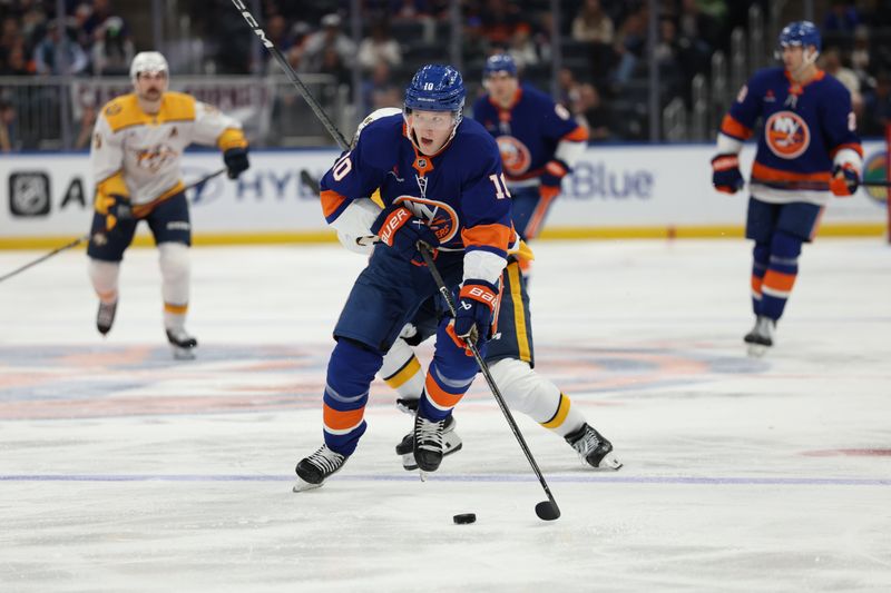 Mar 1, 2025; Elmont, New York, USA; New York Islanders right wing Simon Holmstrom (10) skates with the puck against the Nashville Predators during the second period at UBS Arena. Mandatory Credit: Thomas Salus-Imagn Images