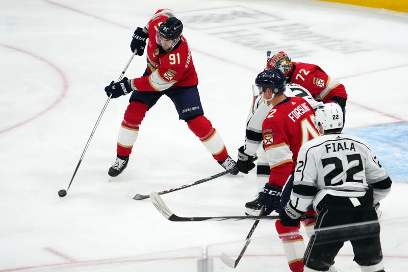 Jan 11, 2024; Sunrise, Florida, USA; Florida Panthers defenseman Oliver Ekman-Larsson (91) clears the puck against the Los Angeles Kings during the third period at Amerant Bank Arena. Mandatory Credit: Jasen Vinlove-USA TODAY Sports