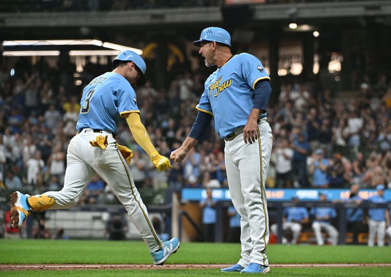 Sep 20, 2024; Milwaukee, Wisconsin, USA; Milwaukee Brewers third base Joey Ortiz (3) is congratulated by third base coach Jason Lane (40) after hitting a home run against the Arizona Diamondbacks in the fifth inning at American Family Field. Mandatory Credit: Michael McLoone-Imagn Images