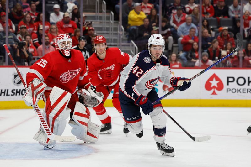 Nov 11, 2023; Detroit, Michigan, USA;  Columbus Blue Jackets center Alexandre Texier (42) chases the puck in front of Detroit Red Wings goaltender Ville Husso (35) in the third period at Little Caesars Arena. Mandatory Credit: Rick Osentoski-USA TODAY Sports