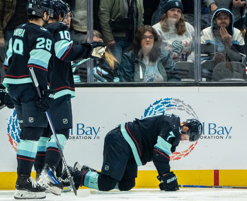 Nov 14, 2024; Seattle, Washington, USA;  Seattle Kraken forward Jordan Eberle (7) remains on the ice after a collision during the second period against the Chicago Blackhawks at Climate Pledge Arena. Mandatory Credit: Stephen Brashear-Imagn Images