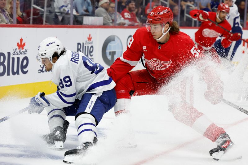 Oct 3, 2024; Detroit, Michigan, USA;  Toronto Maple Leafs left wing Nicholas Robertson (89) skates with the puck defended by Detroit Red Wings defenseman Moritz Seider (53) in the first period at Little Caesars Arena. Mandatory Credit: Rick Osentoski-Imagn Images