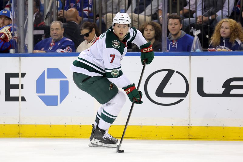 Oct 20, 2025; New York, New York, USA; Minnesota Wild defenseman Brock Faber (7) skates with the puck against the New York Rangers during the second period at Madison Square Garden. Mandatory Credit: Brad Penner-Imagn Images