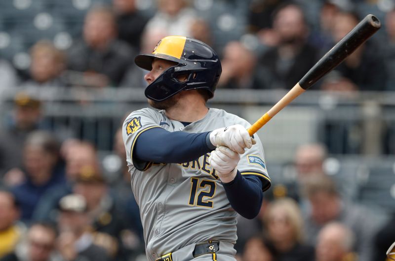 Apr 25, 2024; Pittsburgh, Pennsylvania, USA;  Milwaukee Brewers designated hitter Rhys Hoskins (12) hits an RBI single against the Pittsburgh Pirates during the third inning at PNC Park. Mandatory Credit: Charles LeClaire-USA TODAY Sports