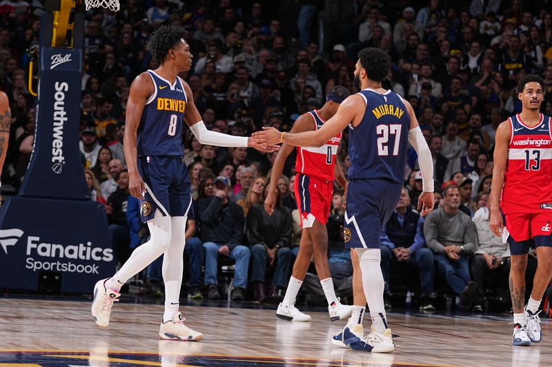 DENVER, CO - FEBRUARY 22: Peyton Watson #8 of the Denver Nuggets high fives Jamal Murray #27 during the game against the Washington Wizards on February 22, 2024 at the Ball Arena in Denver, Colorado. NOTE TO USER: User expressly acknowledges and agrees that, by downloading and/or using this Photograph, user is consenting to the terms and conditions of the Getty Images License Agreement. Mandatory Copyright Notice: Copyright 2024 NBAE (Photo by Bart Young/NBAE via Getty Images)