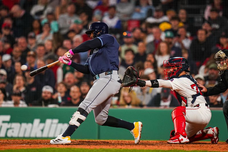 Jun 10, 2025; Boston, Massachusetts, USA; Tampa Bay Rays first base Yandy Díaz (2) gets a base hit to drive in a run against the Boston Red Sox in the fifth inning at Fenway Park. Mandatory Credit: David Butler II-Imagn Images
