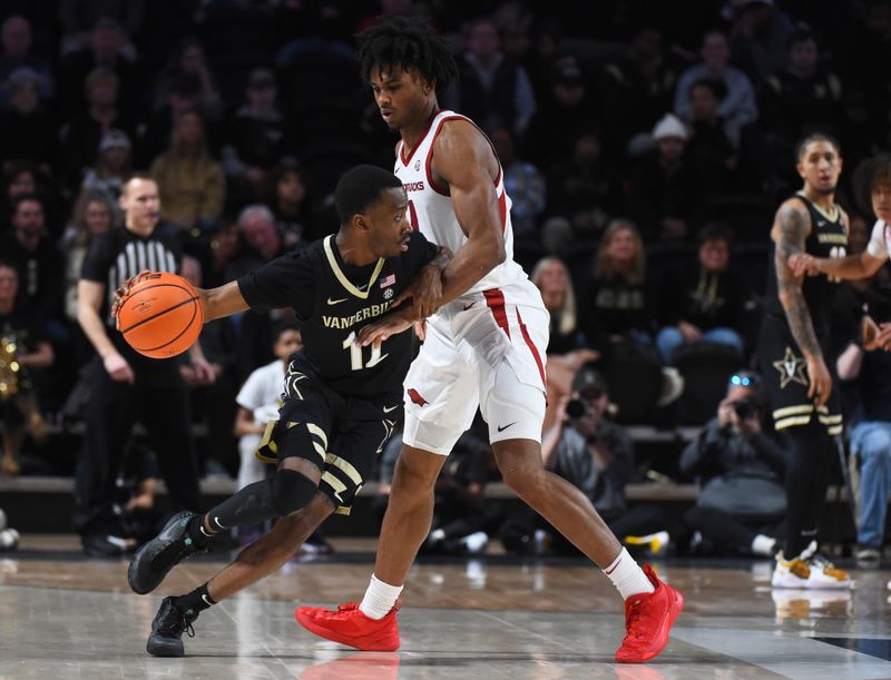 Jan 14, 2023; Nashville, Tennessee, USA; Vanderbilt Commodores guard Trey Thomas (12) is defended by Arkansas Razorbacks guard Ricky Council IV (1) during the second half at Memorial Gymnasium. Mandatory Credit: Christopher Hanewinckel-USA TODAY Sports