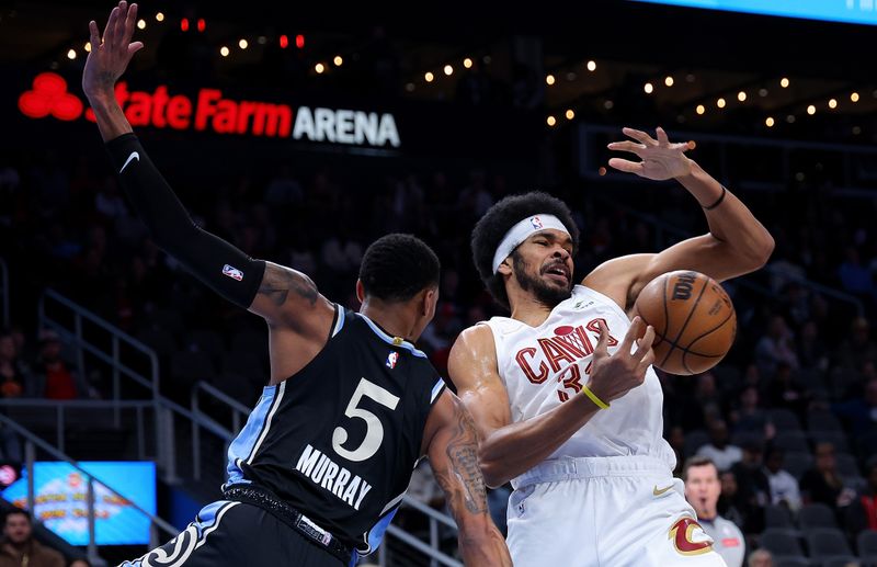 ATLANTA, GEORGIA - MARCH 06:  Dejounte Murray #5 of the Atlanta Hawks defends against Jarrett Allen #31 of the Cleveland Cavaliers during the first quarter at State Farm Arena on March 06, 2024 in Atlanta, Georgia.  NOTE TO USER: User expressly acknowledges and agrees that, by downloading and/or using this photograph, user is consenting to the terms and conditions of the Getty Images License Agreement.  (Photo by Kevin C. Cox/Getty Images)