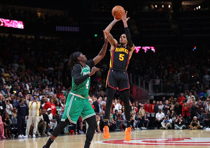 ATLANTA, GEORGIA - MARCH 28:  Dejounte Murray #5 of the Atlanta Hawks hits the game-winning basket against Jrue Holiday #4 of the Boston Celtics during overtime at State Farm Arena on March 28, 2024 in Atlanta, Georgia.  NOTE TO USER: User expressly acknowledges and agrees that, by downloading and/or using this photograph, user is consenting to the terms and conditions of the Getty Images License Agreement.  (Photo by Kevin C. Cox/Getty Images)