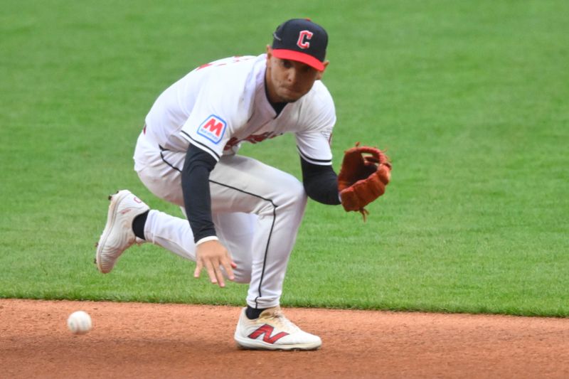 Apr 10, 2024; Cleveland, Ohio, USA; Cleveland Guardians second base Andrés Giménez (0) fields a ground ball in the first inning against the Chicago White Sox at Progressive Field. Mandatory Credit: David Richard-USA TODAY Sports