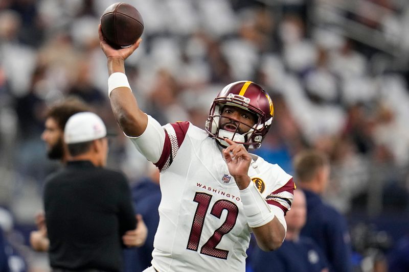 Washington Commanders quarterback Jacoby Brissett warms up before an NFL football game against the Dallas Cowboys Thursday, Nov. 23, 2023, in Arlington, Texas. (AP Photo/Julio Cortez)