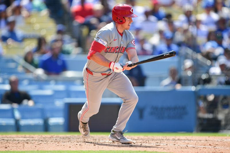 May 19, 2024; Los Angeles, California, USA; Cincinnati Reds outfielder Jacob Hurtubise (26) hits a single against the Los Angeles Dodgers during the ninth inning at Dodger Stadium. Mandatory Credit: Gary A. Vasquez-USA TODAY Sports