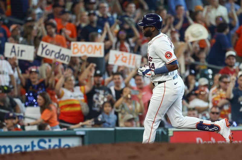 Jun 22, 2024; Houston, Texas, USA; Fans hold signs as Houston Astros designated hitter Yordan Alvarez (44) rounds the bases after hitting a home run during the third inning against the Baltimore Orioles at Minute Maid Park. Mandatory Credit: Troy Taormina-USA TODAY Sports