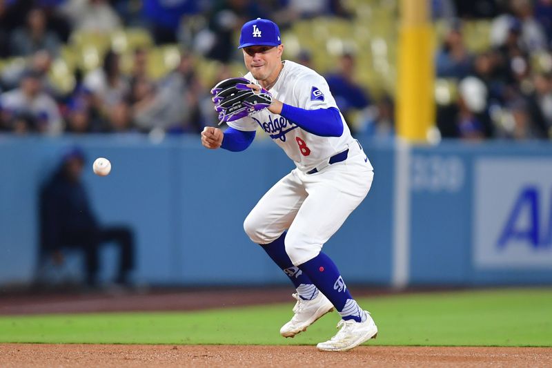 May 22, 2024; Los Angeles, California, USA; Los Angeles Dodgers third baseman Enrique Hernandez (8) fields the ground ball of Arizona Diamondbacks shortstop Blaze Alexander (9) during the eighth inning at Dodger Stadium. Mandatory Credit: Gary A. Vasquez-USA TODAY Sports