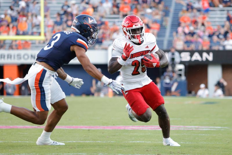 Oct 12, 2024; Charlottesville, Virginia, USA; Louisville Cardinals running back Isaac Brown (25) carries the ball past Virginia Cavaliers safety Corey Thomas Jr. (3) to score a touchdown during the second half at Scott Stadium. Mandatory Credit: Amber Searls-Imagn Images