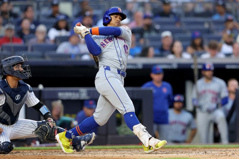 Jul 23, 2024; Bronx, New York, USA; New York Mets shortstop Francisco Lindor (12) follows through on a double against the New York Yankees during the third inning at Yankee Stadium. Mandatory Credit: Brad Penner-USA TODAY Sports