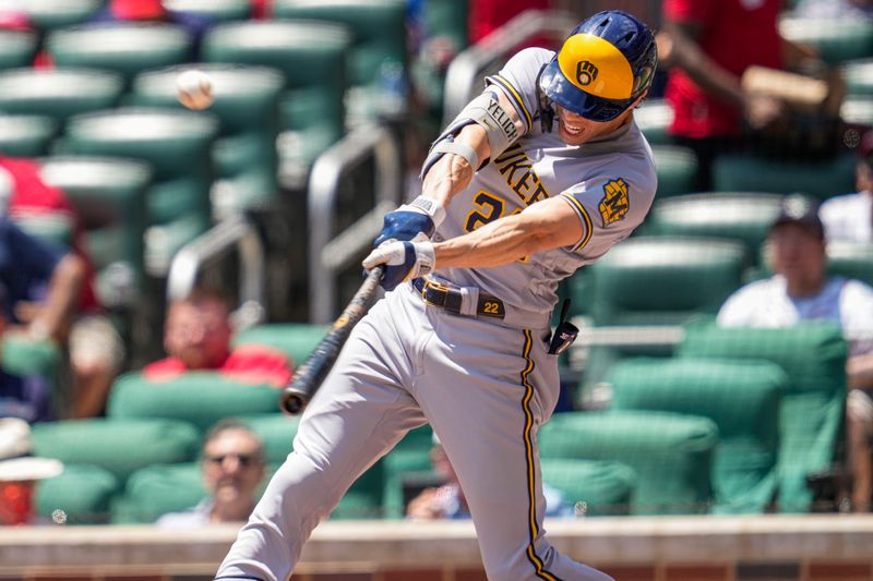 Jul 30, 2023; Cumberland, Georgia, USA; Milwaukee Brewers left fielder Christian Yelich (22) hits a home run against the Atlanta Braves during the third inning at Truist Park. Mandatory Credit: Dale Zanine-USA TODAY Sports