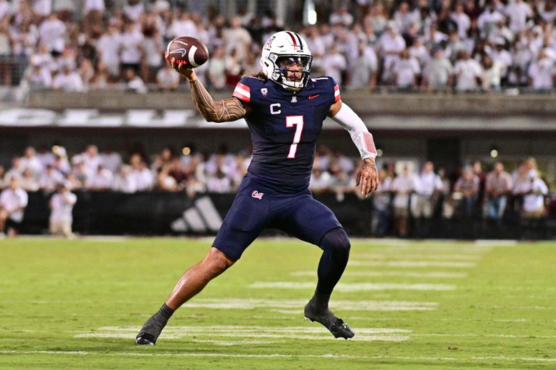 Sep 9, 2023; Starkville, Mississippi, USA; Arizona Wildcats quarterback Jayden de Laura (7) moves in the pocket against the Mississippi State Bulldogs during the second half at Davis Wade Stadium at Scott Field. Mandatory Credit: Matt Bush-USA TODAY Sports