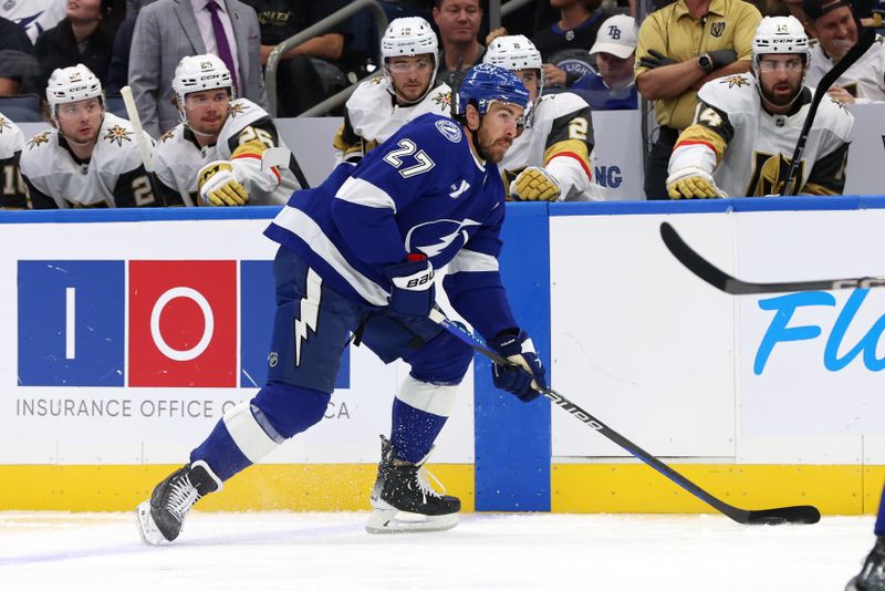 wOct 17, 2024; Tampa, Florida, USA; Tampa Bay Lightning defenseman Ryan McDonagh (27) skates with the puck against the Vegas Golden Knights during the first period at Amalie Arena. Mandatory Credit: Kim Klement Neitzel-Imagn Images