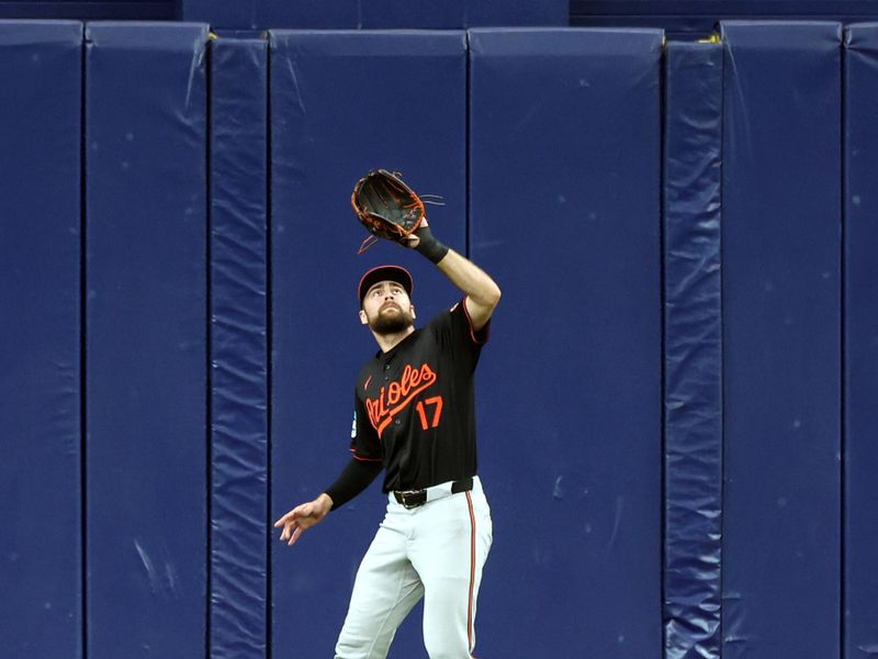 Aug 11, 2024; St. Petersburg, Florida, USA;  Baltimore Orioles outfielder Colton Cowser (17) catches a fly ball against the Tampa Bay Rays during the third inning at Tropicana Field. Mandatory Credit: Kim Klement Neitzel-USA TODAY Sports