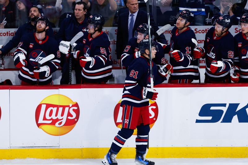 Oct 18, 2024; Winnipeg, Manitoba, CAN;  Winnipeg Jets forward Cole Perfetti (91) is congratulated by his teammates on his goal against the San Jose Sharks during the third period at Canada Life Centre. Mandatory Credit: Terrence Lee-Imagn Images