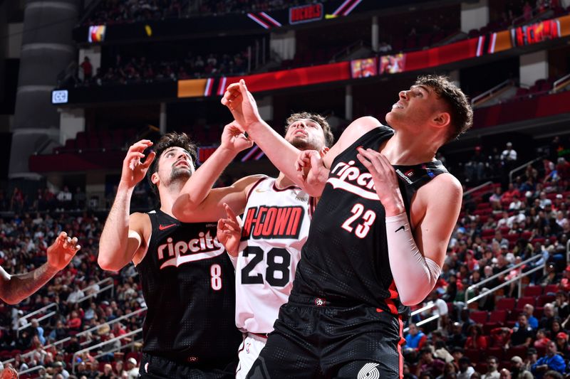 HOUSTON, TX -NOVEMBER 23:  Deni Avdija #8 and Donovan Clingan #23 of the Portland Trail Blazers battle for rebound against Alperen Sengun #28 of the Houston Rockets on November 23, 2024 at the Toyota Center in Houston, Texas. NOTE TO USER: User expressly acknowledges and agrees that, by downloading and or using this photograph, User is consenting to the terms and conditions of the Getty Images License Agreement. Mandatory Copyright Notice: Copyright 2024 NBAE (Photo by Logan Riely/NBAE via Getty Images)