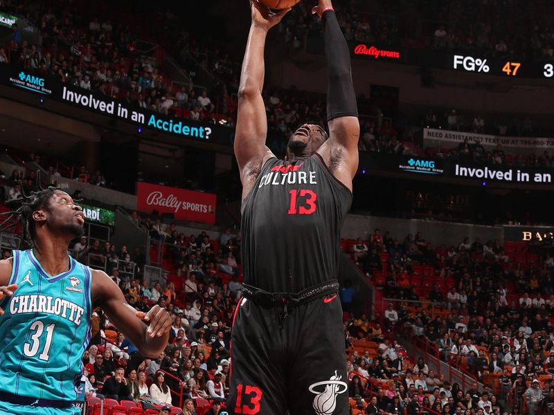 MIAMI, FL - JANUARY 14: Bam Adebayo #13 of the Miami Heat rebounds during the game against the Charlotte Hornets on January 14, 2024 at Kaseya Center in Miami, Florida. NOTE TO USER: User expressly acknowledges and agrees that, by downloading and or using this Photograph, user is consenting to the terms and conditions of the Getty Images License Agreement. Mandatory Copyright Notice: Copyright 2024 NBAE (Photo by Issac Baldizon/NBAE via Getty Images)