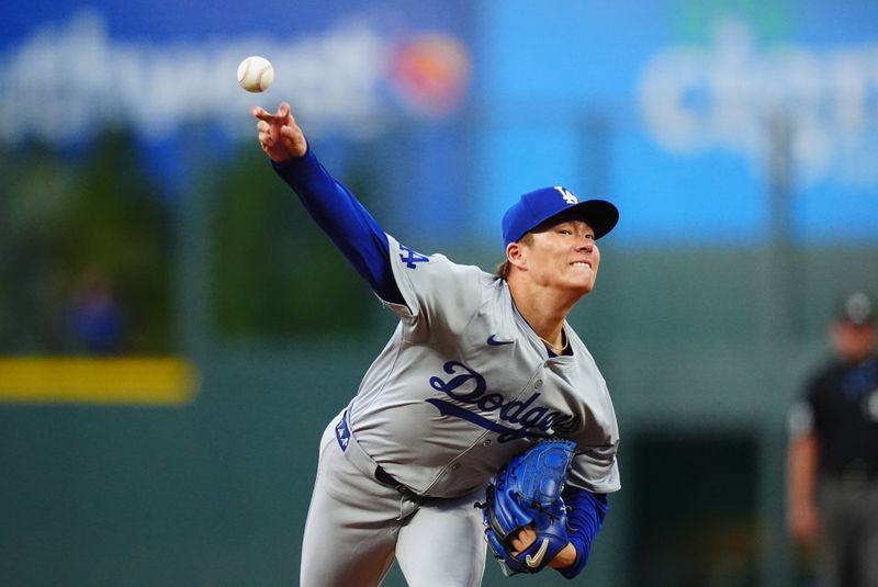 Sep 28, 2024; Denver, Colorado, USA; Los Angeles Dodgers pitcher Yoshinobu Yamamoto (18) delivers a pitch in the first inning against the Colorado Rockies at Coors Field. Mandatory Credit: Ron Chenoy-Imagn Images