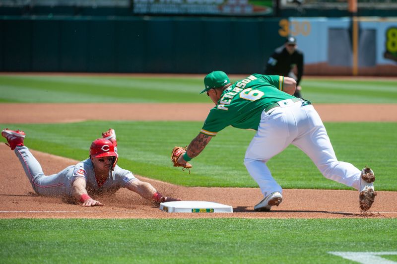 Apr 29, 2023; Oakland, California, USA; Cincinnati Reds first baseman Spencer Steer (7) attempts to steal third base during the first inning against the Oakland Athletics at RingCentral Coliseum. Mandatory Credit: Ed Szczepanski-USA TODAY Sports