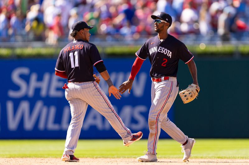 Aug 13, 2023; Philadelphia, Pennsylvania, USA; Minnesota Twins center fielder Michael A. Taylor (2) and second baseman Jorge Polanco (11) celebrate a victory against the Philadelphia Phillies at Citizens Bank Park. Mandatory Credit: Bill Streicher-USA TODAY Sports