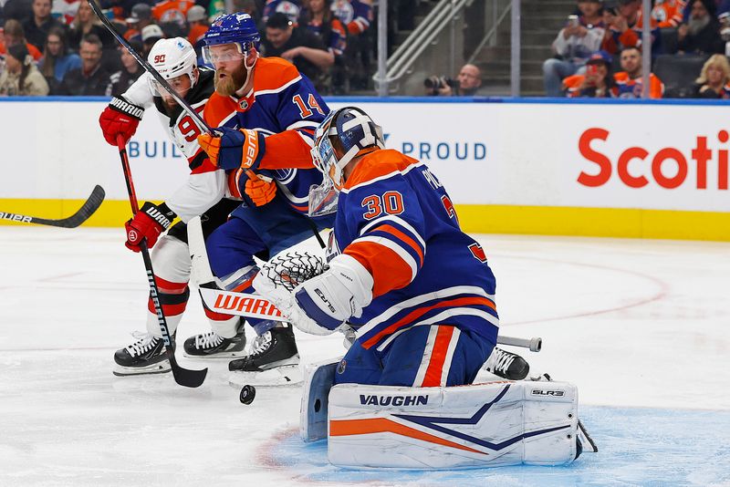 Nov 4, 2024; Edmonton, Alberta, CAN; New Jersey Devils forward Tomas Tatar (90) battles for a loose puck with Edmonton Oilers defensemen Mattias Ekholm (14) in front of goaltender Calvin Pickard (30) during the second period at Rogers Place. Mandatory Credit: Perry Nelson-Imagn Images