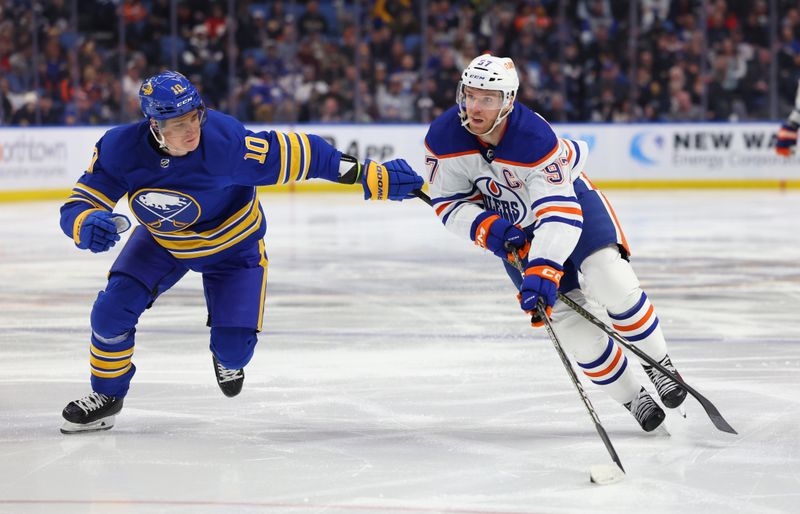 Mar 6, 2023; Buffalo, New York, USA;  Edmonton Oilers center Connor McDavid (97) skates with the puck as Buffalo Sabres defenseman Henri Jokiharju (10) defends during the third period at KeyBank Center. Mandatory Credit: Timothy T. Ludwig-USA TODAY Sports