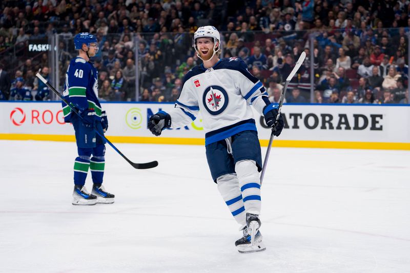 Feb 17, 2024; Vancouver, British Columbia, CAN; Winnipeg Jets forward Kyle Connor (81) celebrates a goal scored by forward Mark Scheifele (55) against the Vancouver Canucks in the third period at Rogers Arena. Jets won 4-2. Mandatory Credit: Bob Frid-USA TODAY Sports