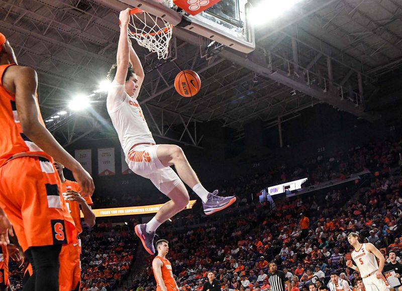 Feb 22, 2023; Clemson, South Carolina, USA; Clemson sophomore forward Ian Schieffelin (4) dunks against Syracuse guard Quadir Copeland (24) during the second half at Littlejohn Coliseum. Mandatory Credit: Ken Ruinard-USA TODAY Sports