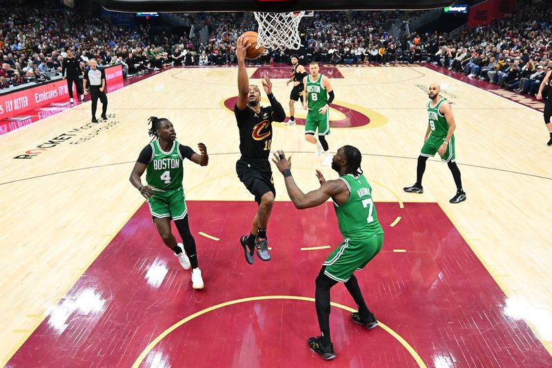 CLEVELAND, OHIO - FEBRUARY 04: Darius Garland #10 of the Cleveland Cavaliers shoots over Jrue Holiday #4 and Jaylen Brown #7 of the Boston Celtics during the second quarter at Rocket Mortgage Fieldhouse on February 04, 2025 in Cleveland, Ohio. The Celtics defeated the Cavaliers 112-105. NOTE TO USER: User expressly acknowledges and agrees that, by downloading and or using this photograph, User is consenting to the terms and conditions of the Getty Images License Agreement. (Photo by Jason Miller/Getty Images)