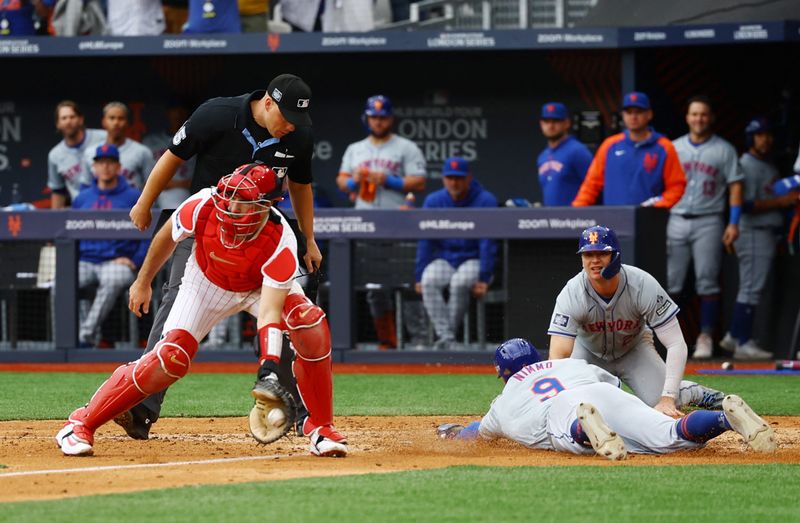 [US, Mexico & Canada customers only] June 9, 2024; London, UNITED KINGDOM;  New York Mets player Brandon Nimmo scores a run past Philadelphia Phillies catcher J.T. Realmuto during a London Series baseball game at Queen Elizabeth Olympic Park. Mandatory Credit: Matthew Childs/Reuters via USA TODAY Sports