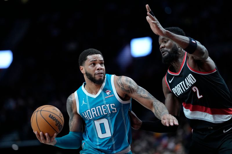 PORTLAND, OREGON - FEBRUARY 25: Miles Bridges #0 of the Charlotte Hornets drives to the basket against Deandre Ayton #2 of the Portland Trail Blazers during the first half at Moda Center on February 25, 2024 in Portland, Oregon. NOTE TO USER: User expressly acknowledges and agrees that, by downloading and or using this photograph, User is consenting to the terms and conditions of the Getty Images License Agreement. (Photo by Soobum Im/Getty Images)