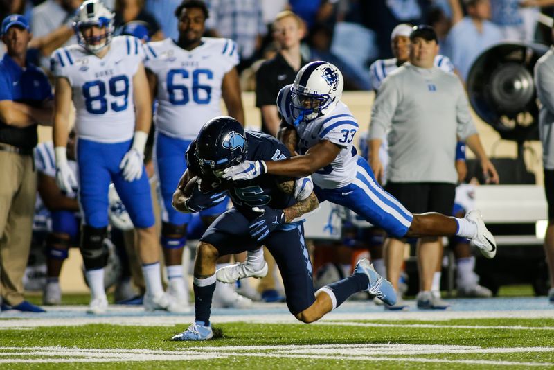 Oct 26, 2019; Chapel Hill, NC, USA; North Carolina Tar Heels wide receiver Beau Corrales, left, fights for yards after a catch against Duke Blue Devils cornerback Leonard Johnson (33) in the second half at Kenan Memorial Stadium. The North Carolina Tar Heels won 20-17. Mandatory Credit: Nell Redmond-USA TODAY Sports