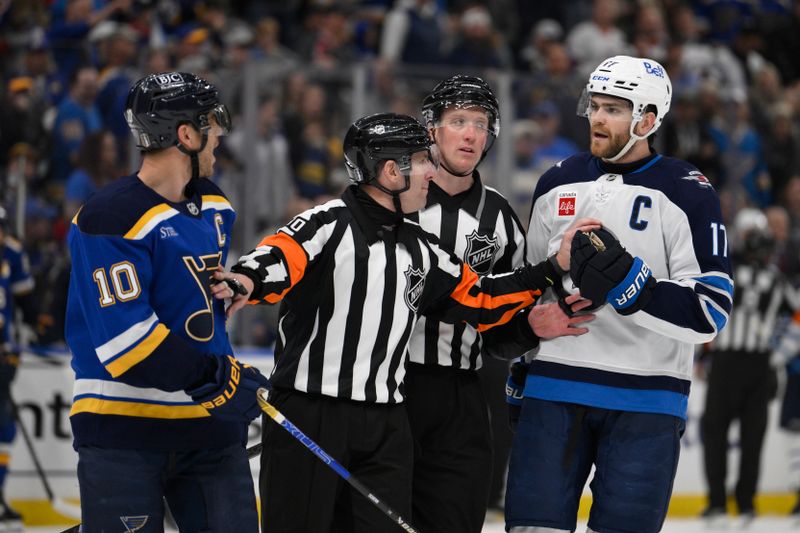 Apr 27, 2025; St. Louis, Missouri, USA; St. Louis Blues center Brayden Schenn (10) talks to Winnipeg Jets center Adam Lowry (17) during the third period in game four of the first round of the 2025 Stanley Cup Playoffs at Enterprise Center. Mandatory Credit: Jeff Le-Imagn Images