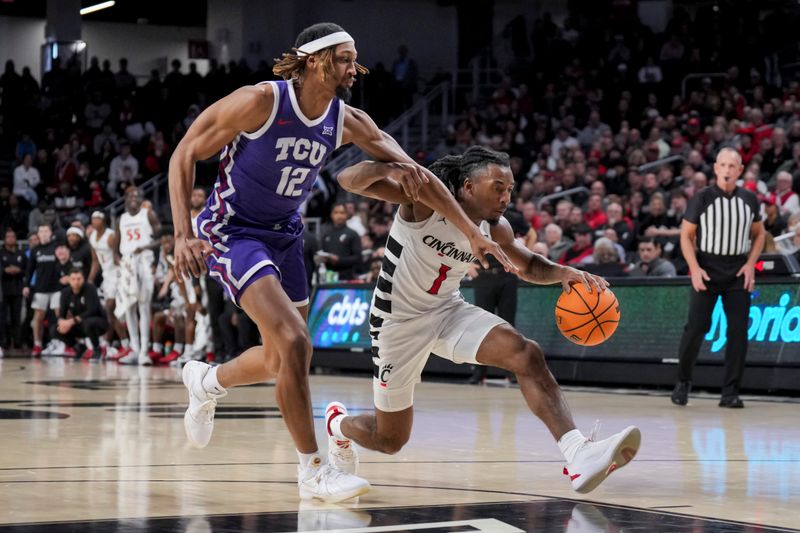 Jan 16, 2024; Cincinnati, Ohio, USA;  Cincinnati Bearcats guard Day Day Thomas (1) drives to the basket against TCU Horned Frogs forward Xavier Cork (12) in the first half at Fifth Third Arena. Mandatory Credit: Aaron Doster-USA TODAY Sports