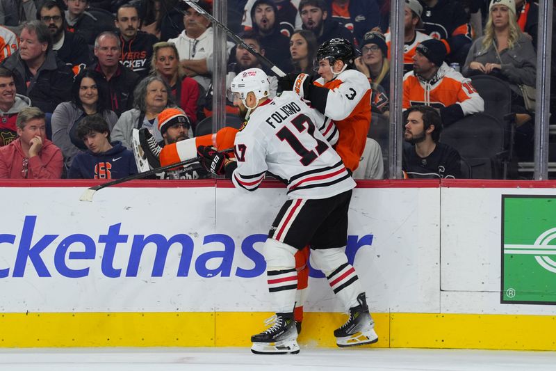 Nov 23, 2024; Philadelphia, Pennsylvania, USA; Chicago Blackhawks left wing Nick Foligno (17) hits Philadelphia Flyers defenseman Helge Grans (3) in the second period at Wells Fargo Center. Mandatory Credit: Kyle Ross-Imagn Images