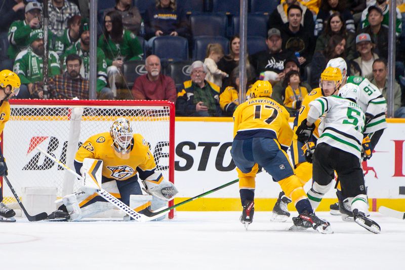 Feb 15, 2024; Nashville, Tennessee, USA; Dallas Stars center Wyatt Johnston (53) scores past Nashville Predators goalie Kevin Lankinen (32) during the third period at Bridgestone Arena. Mandatory Credit: Steve Roberts-USA TODAY Sports