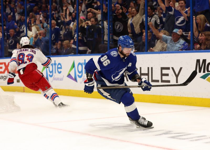 Mar 14, 2024; Tampa, Florida, USA; Tampa Bay Lightning right wing Nikita Kucherov (86) scores a goal as New York Rangers center Mika Zibanejad (93) attempted to defend during the third period at Amalie Arena. Mandatory Credit: Kim Klement Neitzel-USA TODAY Sports