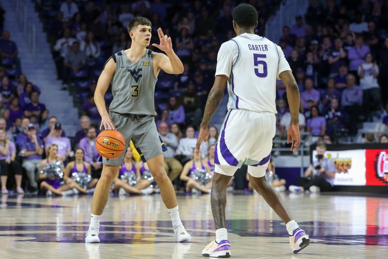 Feb 26, 2024; Manhattan, Kansas, USA; West Virginia Mountaineers guard Kerr Kriisa (3) signals a play while Kansas State Wildcats guard Cam Carter (5) defends during overtime at Bramlage Coliseum. Mandatory Credit: Scott Sewell-USA TODAY Sports