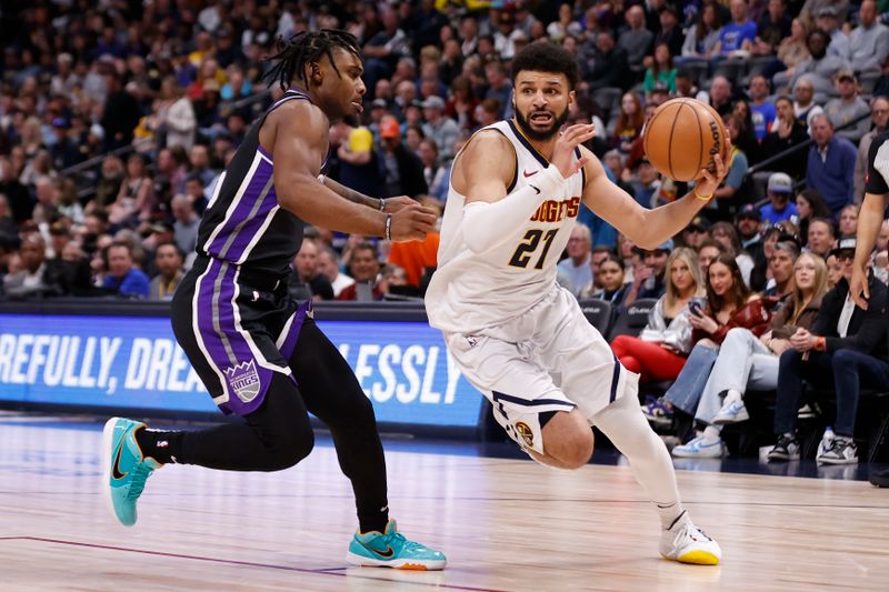 DENVER, COLORADO - FEBRUARY 28: Jamal Murray #27 of the Denver Nuggets brings the ball up court against Davion Mitchell #15 of the Sacramento Kings at Ball Arena on February 28, 2024 in Denver, Colorado. NOTE TO USER: User expressly acknowledges and agrees that, by downloading and or using this photograph, User is consenting to the terms and conditions of the Getty Images License Agreement. (Photo by Brendall O'Banon/Clarkson Creative/Getty Images)