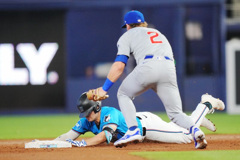 Aug 25, 2024; Miami, Florida, USA;  Miami Marlins first baseman Jonah Bride (41) slides into second base with a double as Chicago Cubs second baseman Nico Hoerner (2) applies the tag at loanDepot Park. Mandatory Credit: Jim Rassol-USA TODAY Sports