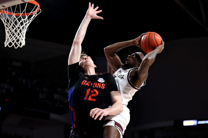 Jan 18, 2023; College Station, Texas, USA; Texas A&M Aggies guard Tyrece Radford (23) drives to the basket while Florida Gators forward Colin Castleton (12) defends during the second half at Reed Arena. Mandatory Credit: Erik Williams-USA TODAY Sports
