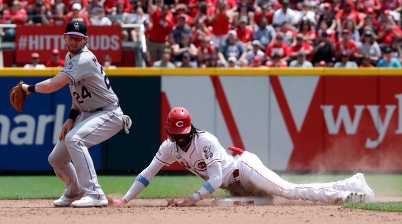 Jun 21, 2023; Cincinnati, Ohio, USA; Cincinnati Reds shortstop Elly De La Cruz (44) slides into second for a double against Colorado Rockies third baseman Ryan McMahon (24) during the eighth inning at Great American Ball Park. Mandatory Credit: David Kohl-USA TODAY Sports