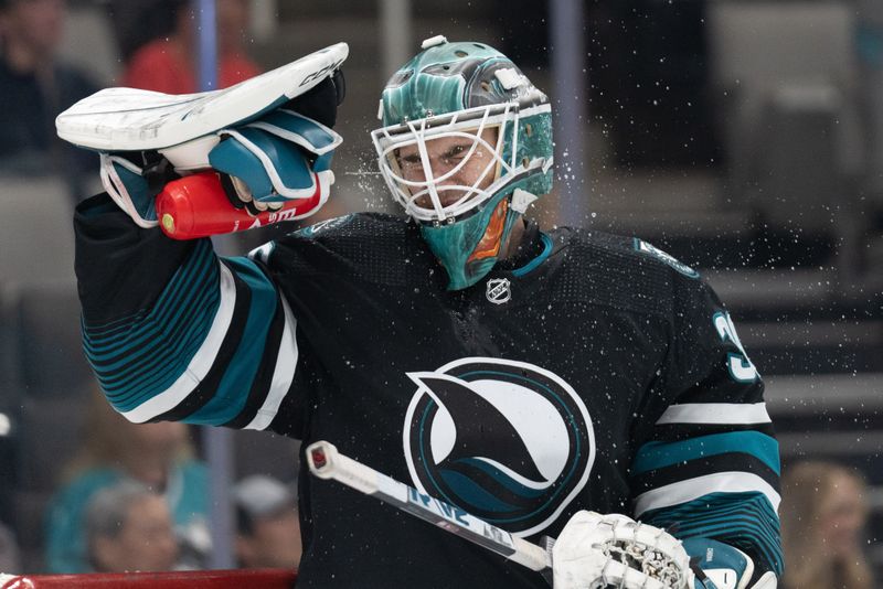 Mar 7, 2024; San Jose, California, USA; San Jose Sharks goaltender Magnus Chrona (30) sprays water on his face during the third period against the New York Islanders at SAP Center at San Jose. Mandatory Credit: Stan Szeto-USA TODAY Sports