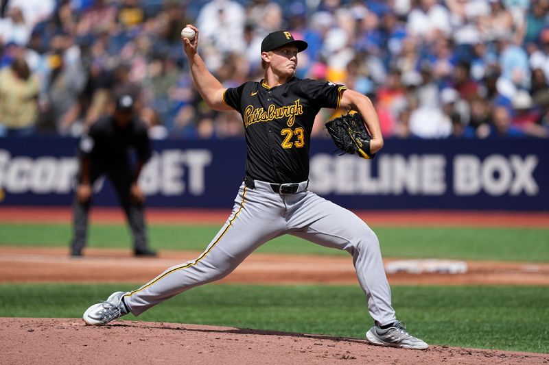 Jun 1, 2024; Toronto, Ontario, CAN; Pittsburgh Pirates starting pitcher Mitch Keller (23) throws against the Toronto Blue Jays during the first inning at Rogers Centre. Mandatory Credit: John E. Sokolowski-USA TODAY Sports